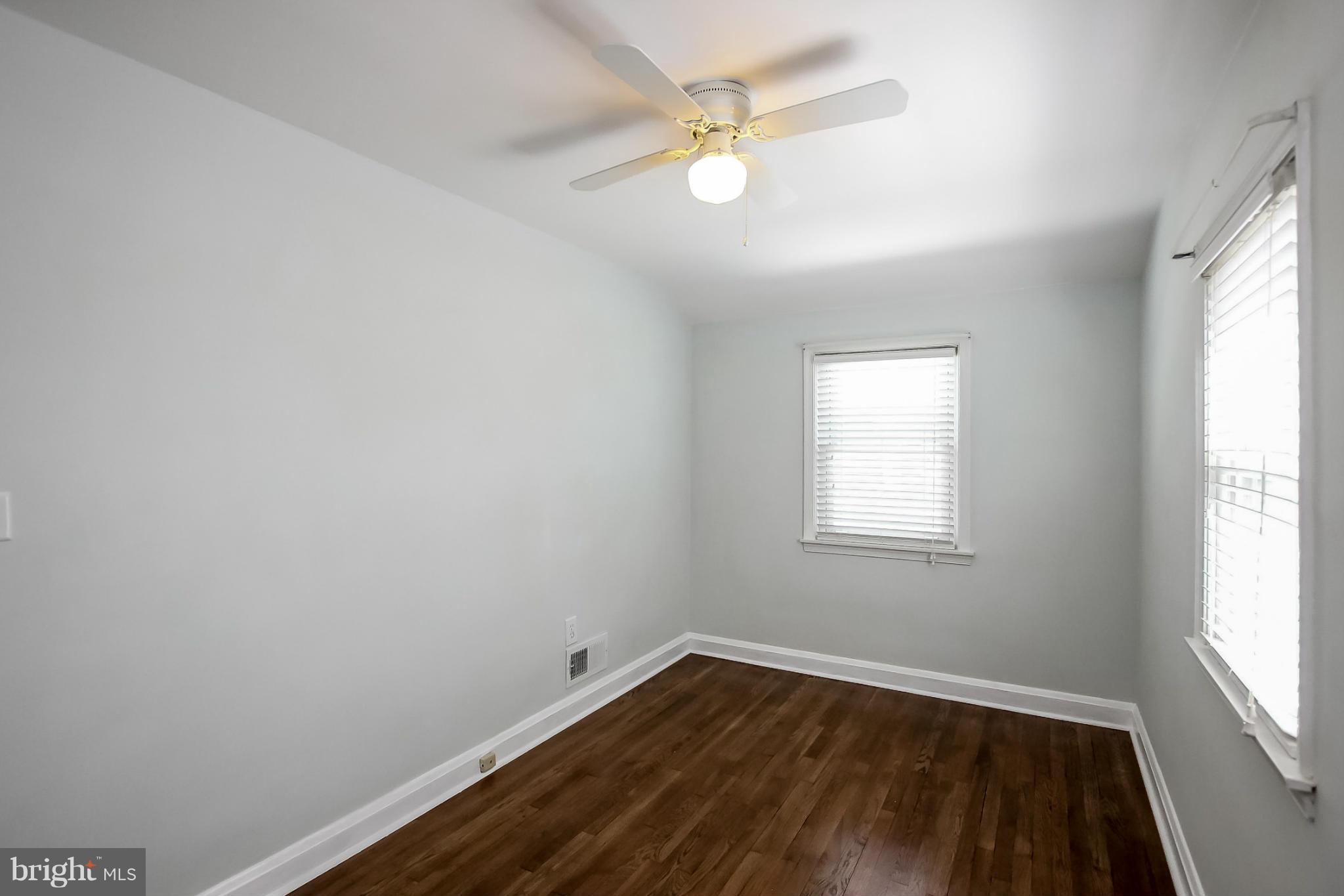 8329 Kavanagh Road Baltimore, MD 21222 - Photo 22 of 30 an empty room with a window and wooden floor