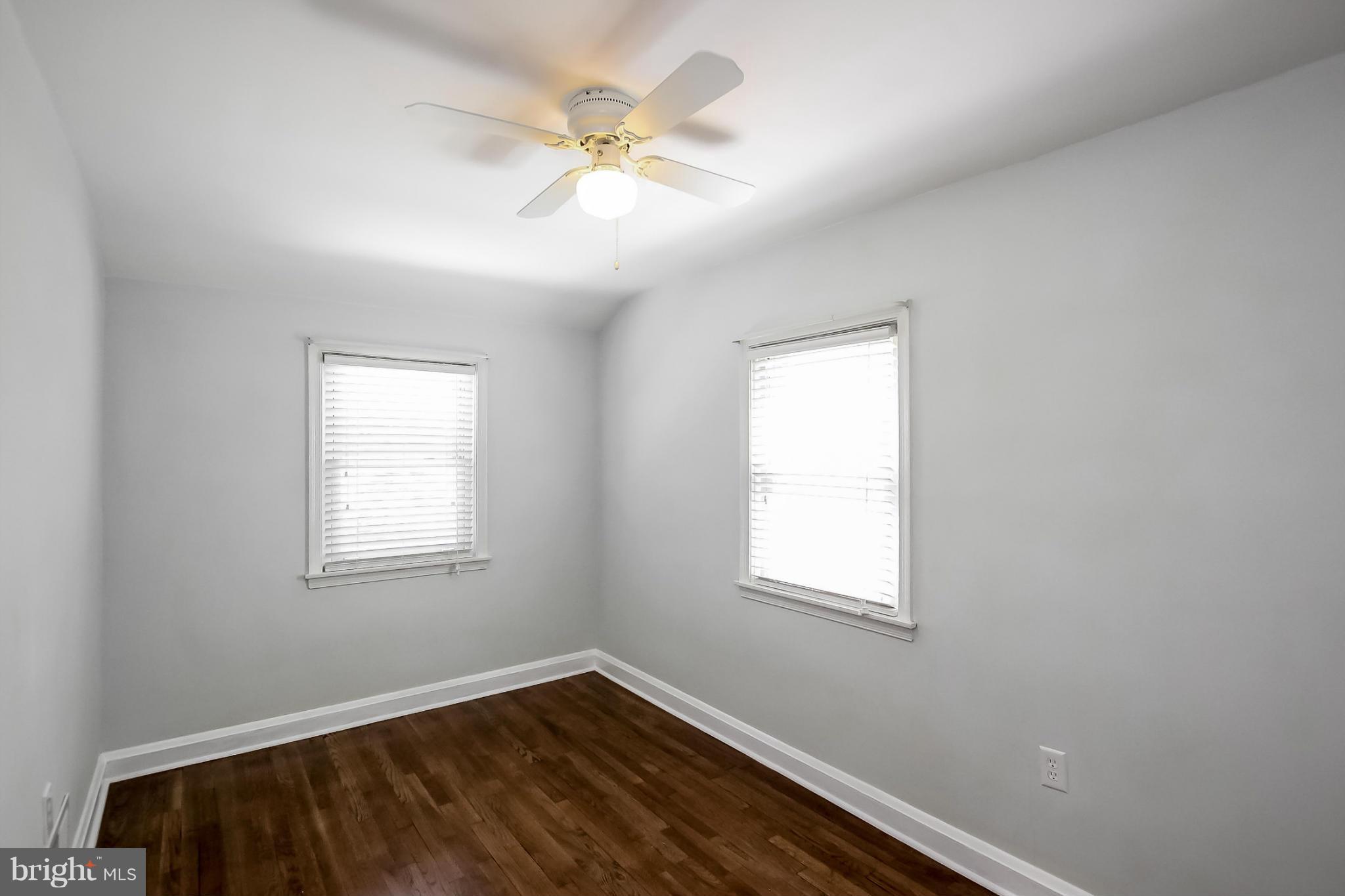 8329 Kavanagh Road Baltimore, MD 21222 - Photo 24 of 30 an empty room with wooden floor and windows