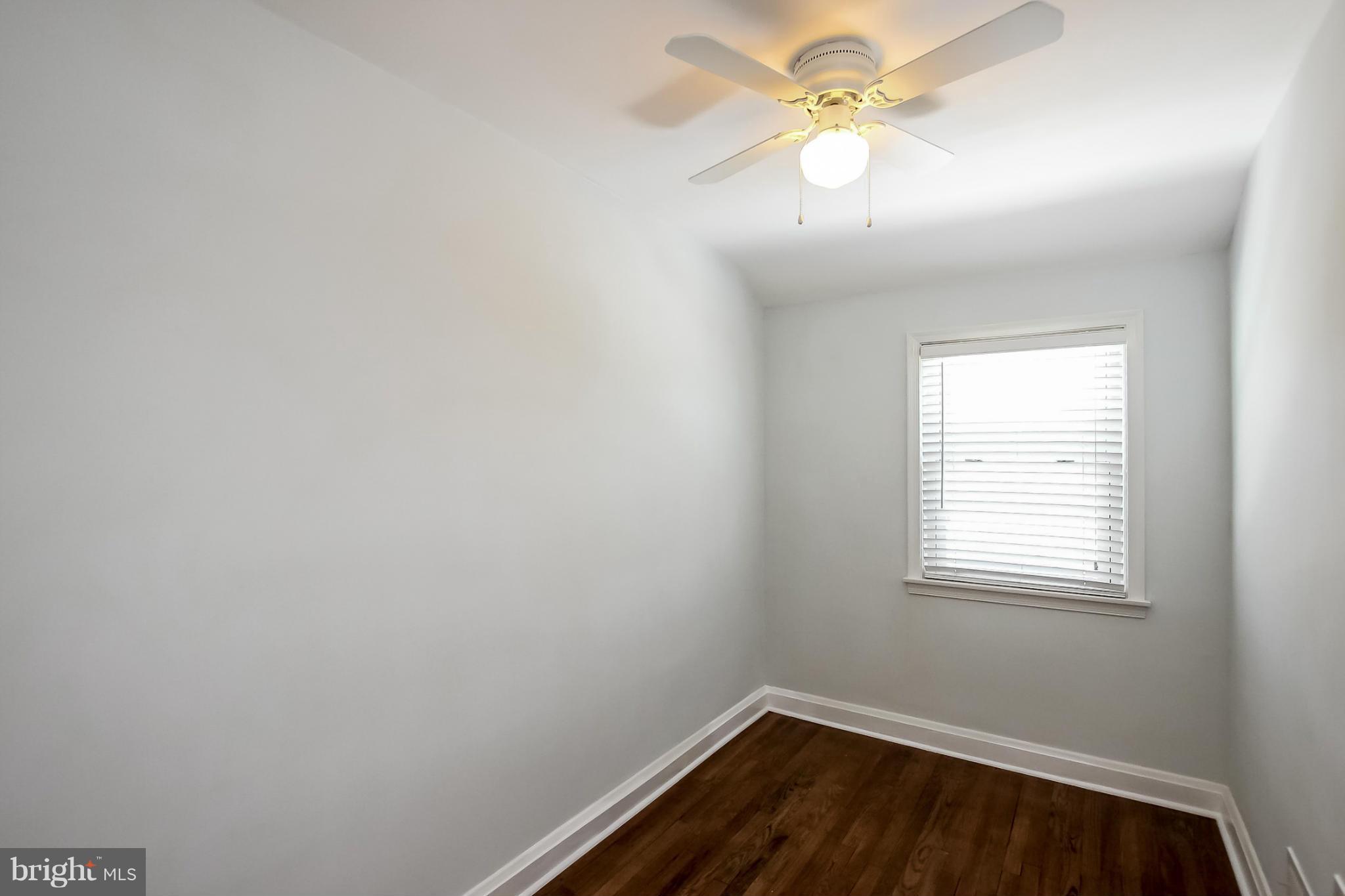 8329 Kavanagh Road Baltimore, MD 21222 - Photo 27 of 30 an empty room with a window and a fan