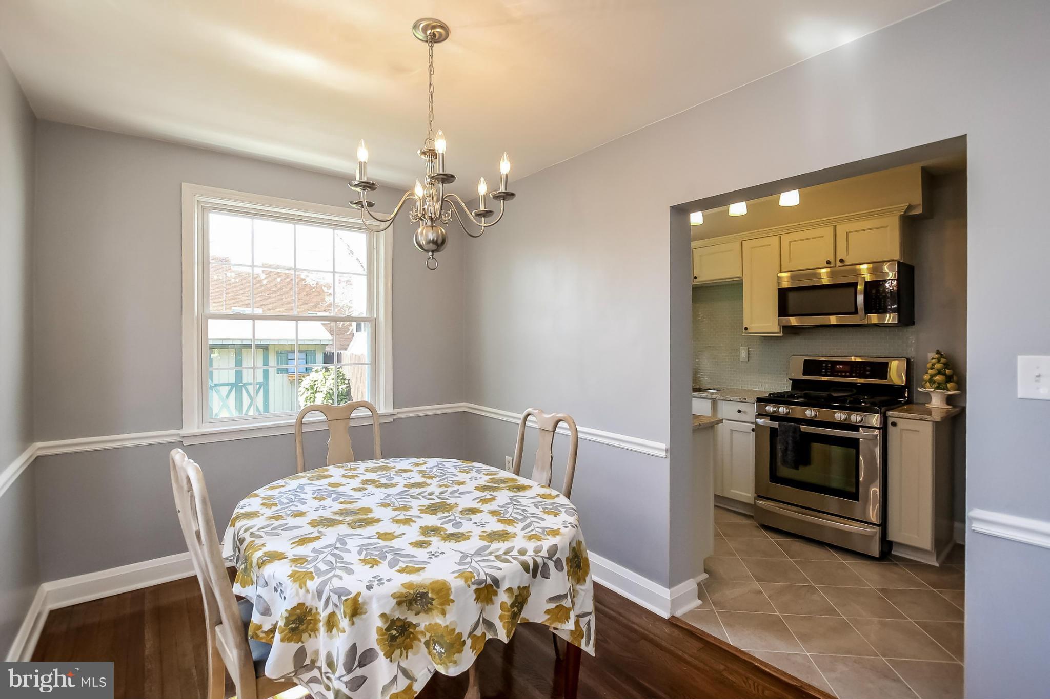 8329 Kavanagh Road Baltimore, MD 21222 - Photo 7 of 30 a spacious bedroom with a bed and a chandelier