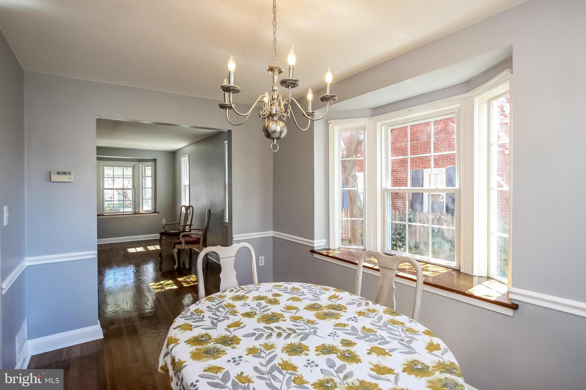 8329 Kavanagh Road Baltimore, MD 21222 - Photo 9 of 30 a spacious bedroom with a large bed and a chandelier