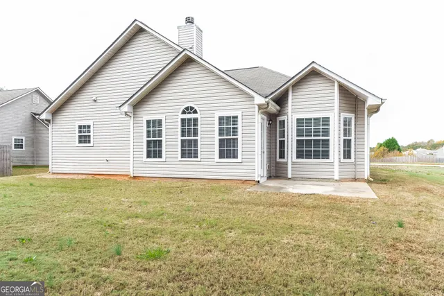 a view of a house with pool and a yard