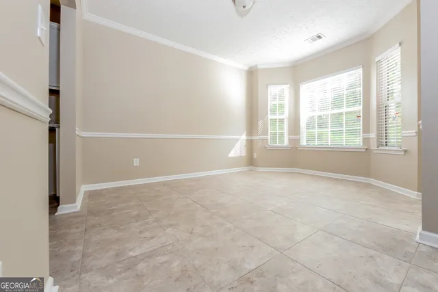 an empty room with windows and entrance