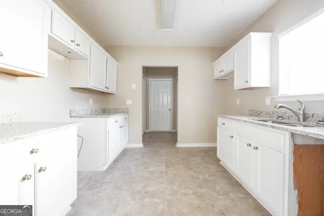 a view of a kitchen with granite countertop cabinets
