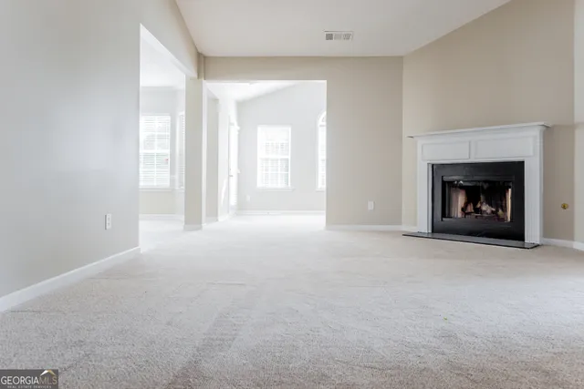 a view of empty room with a fireplace
