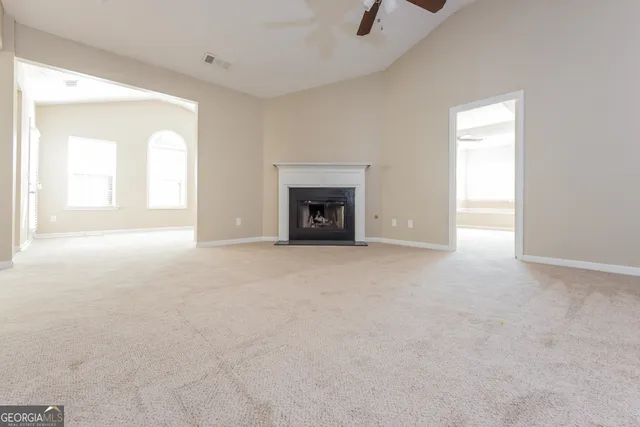 a view of empty room with a fireplace