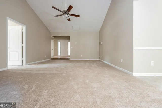 a view of a livingroom with a ceiling fan and window