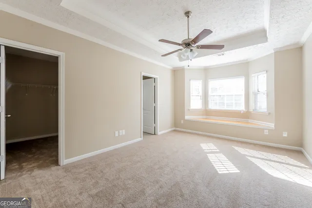 a view of a livingroom with a ceiling fan and window