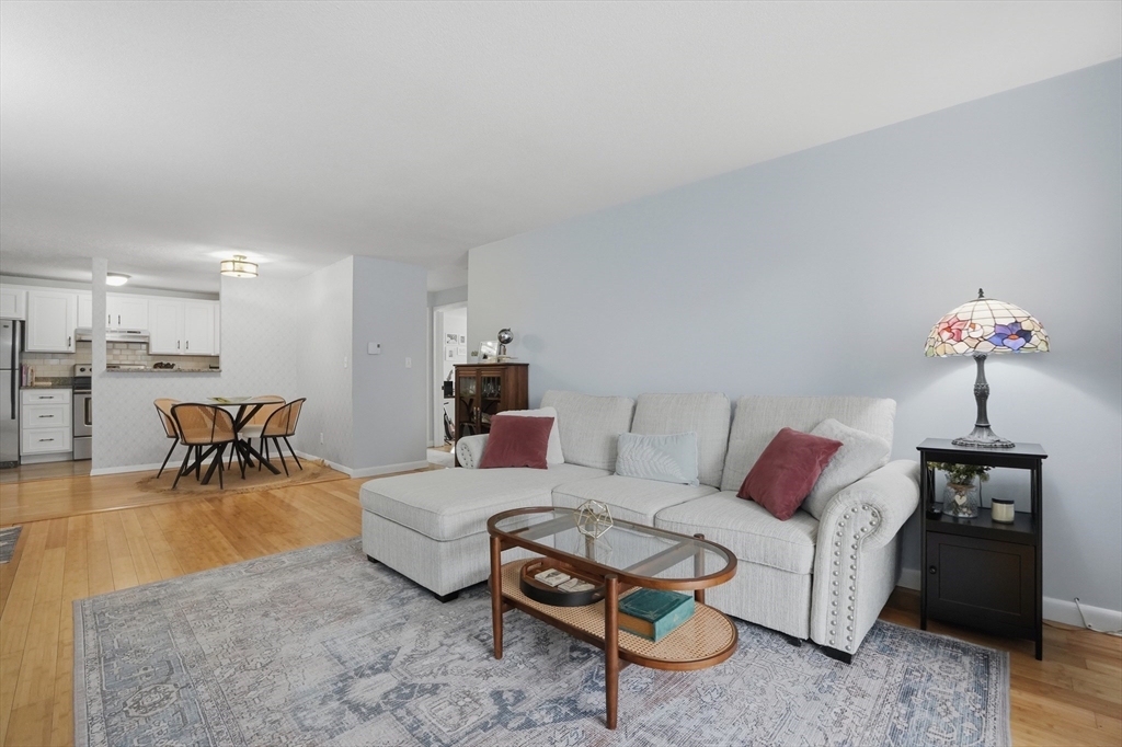 200 Manning Street, Unit 11C Hudson, MA 01749 - Photo 1 of 30 a living room with furniture and a chandelier