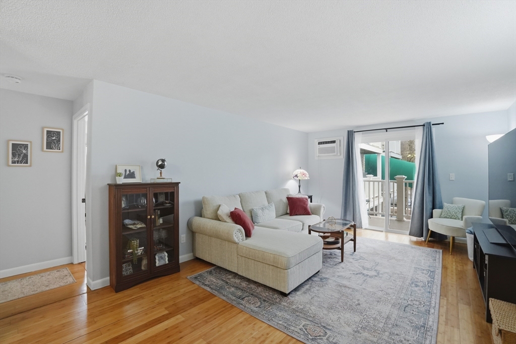 200 Manning Street, Unit 11C Hudson, MA 01749 - Photo 3 of 30 a living room with furniture and wooden floor