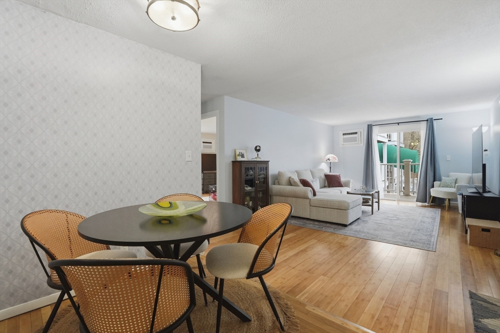 200 Manning Street, Unit 11C Hudson, MA 01749 - Photo 5 of 30 a view of a dining room with furniture and wooden floor