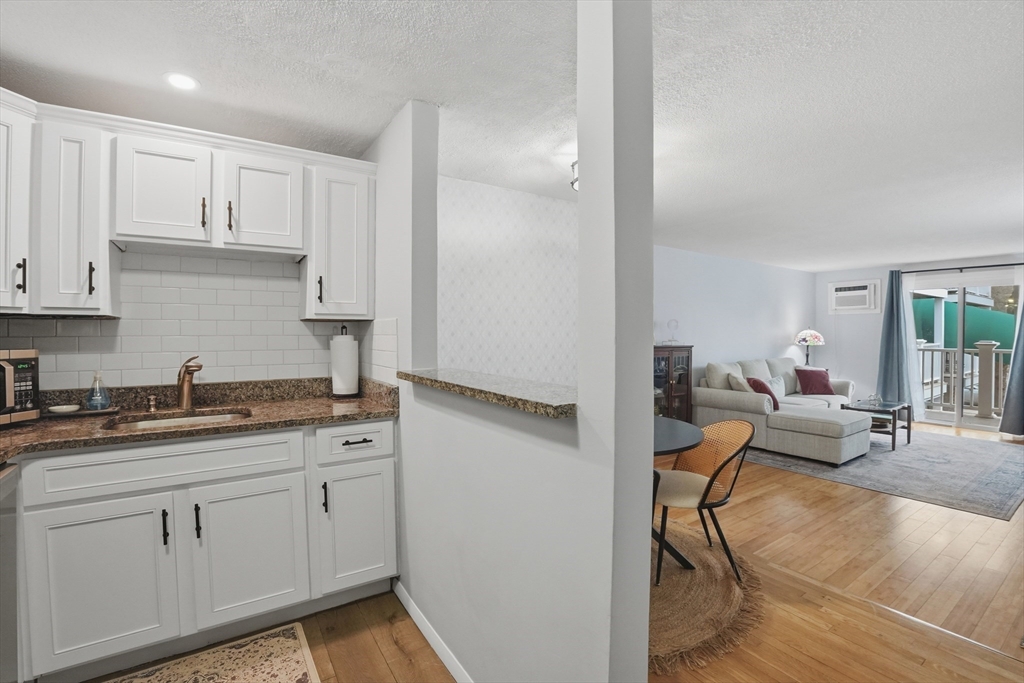 200 Manning Street, Unit 11C Hudson, MA 01749 - Photo 10 of 30 a kitchen with white cabinets and sink