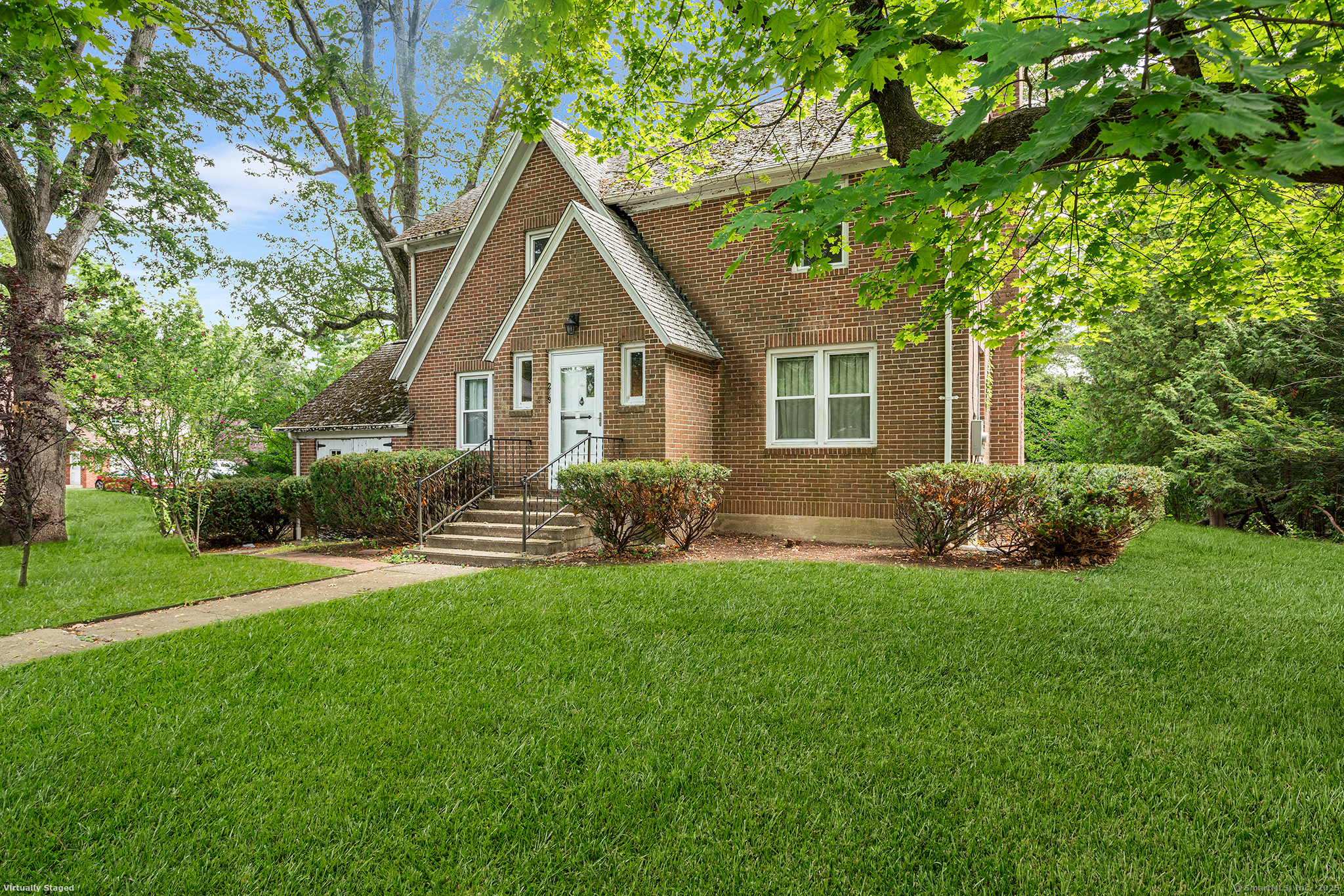 a front view of house with yard and green space