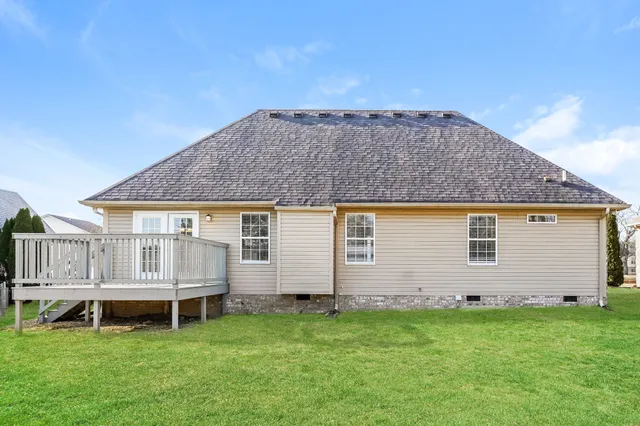 a view of a house with a backyard