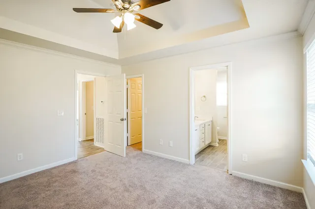 a view of a room with a ceiling fan and closet area