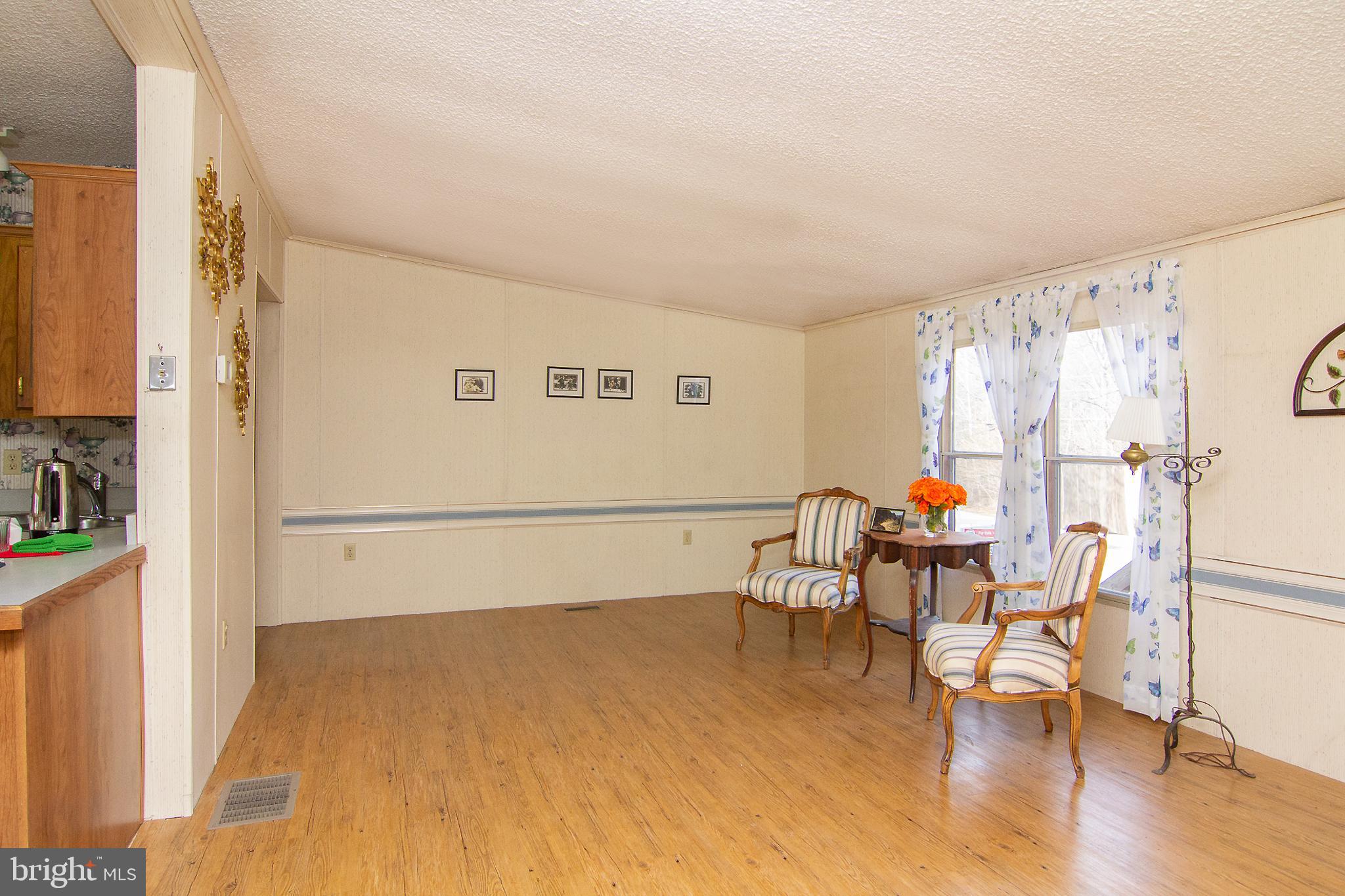 2439 Fairmount Road, Unit 20 Hampstead, MD 21074 - Photo 12 of 29 Family Room with Vinyl Flooring