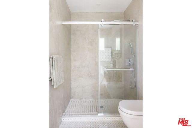 a bathroom with a shower and a toilet