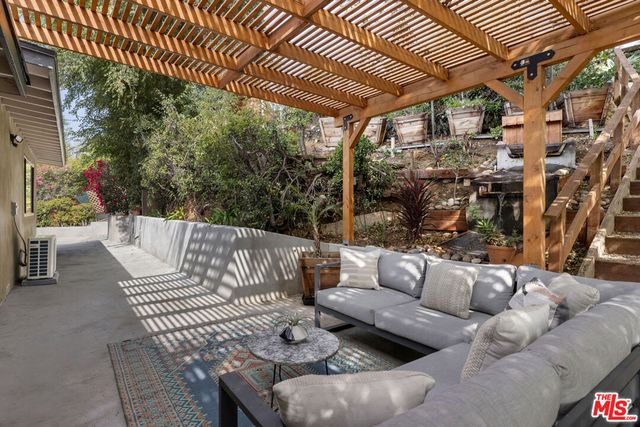 a roof deck with couches and wooden floor