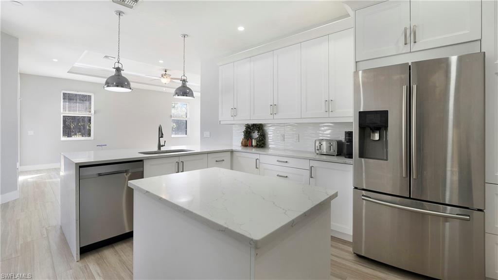 770 17th Street Southwest Naples, FL 34117 - Photo 15 of 47 a kitchen with stainless steel appliances a refrigerator sink and cabinets