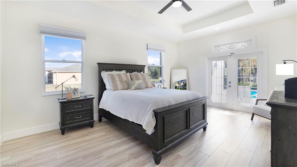 770 17th Street Southwest Naples, FL 34117 - Photo 19 of 47 a bedroom with a bed and wooden floor