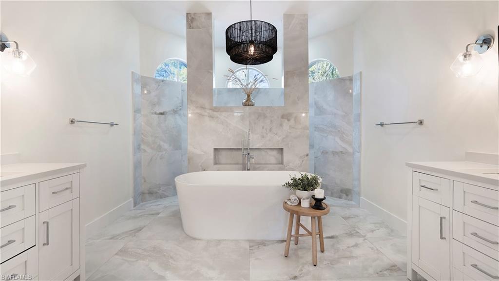 770 17th Street Southwest Naples, FL 34117 - Photo 20 of 47 a bathroom with a sink a bathtub and a shower