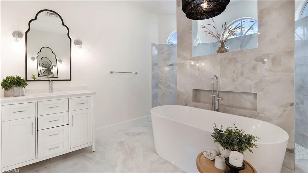 770 17th Street Southwest Naples, FL 34117 - Photo 21 of 47 a bathroom with a sink a bathtub and a potted plant
