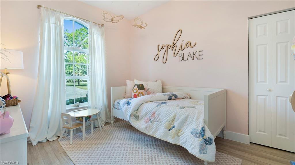770 17th Street Southwest Naples, FL 34117 - Photo 23 of 47 a bedroom with a bed and a table chair