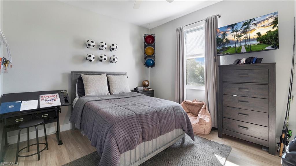 770 17th Street Southwest Naples, FL 34117 - Photo 25 of 47 a bedroom with a bed and a flat screen tv