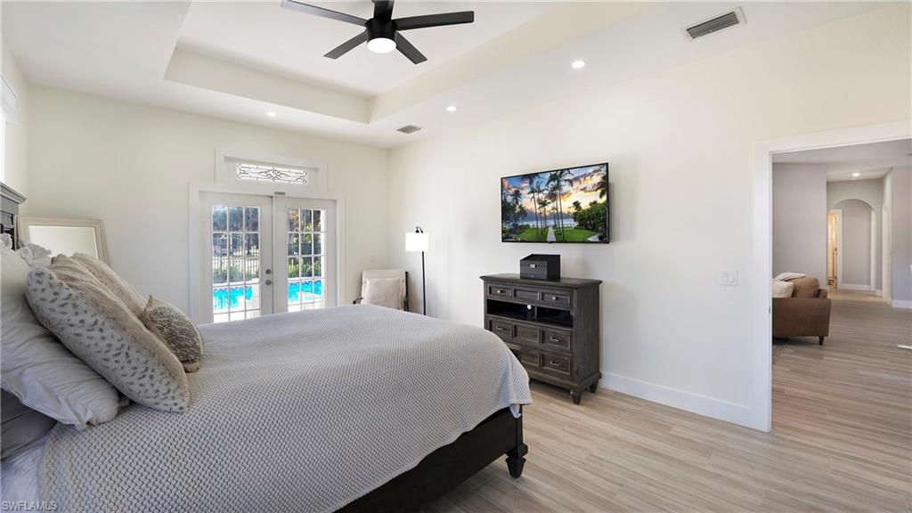 770 17th Street Southwest Naples, FL 34117 - Photo 26 of 47 a bedroom with a bed and a flat screen tv