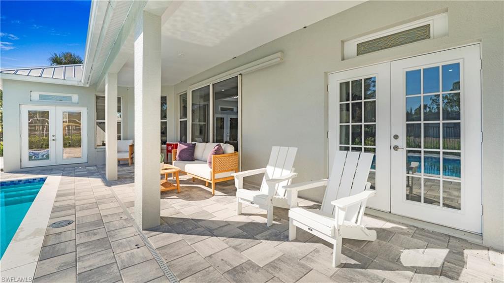 770 17th Street Southwest Naples, FL 34117 - Photo 29 of 47 a view of a two chairs in the patio of the house