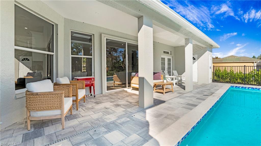 770 17th Street Southwest Naples, FL 34117 - Photo 30 of 47 a view of a swimming pool with lounge chair
