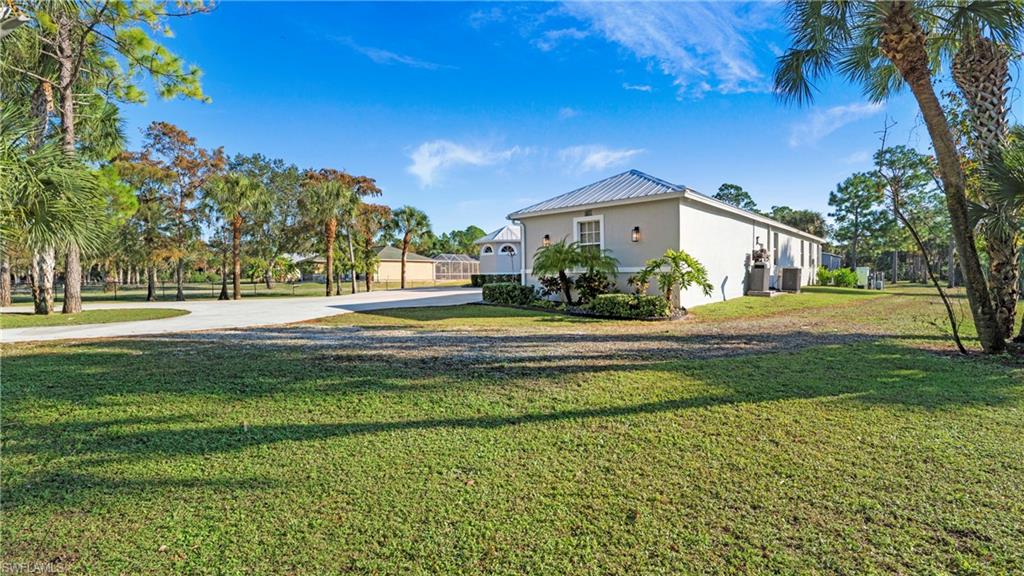 770 17th Street Southwest Naples, FL 34117 - Photo 35 of 47 a front view of a house with a yard