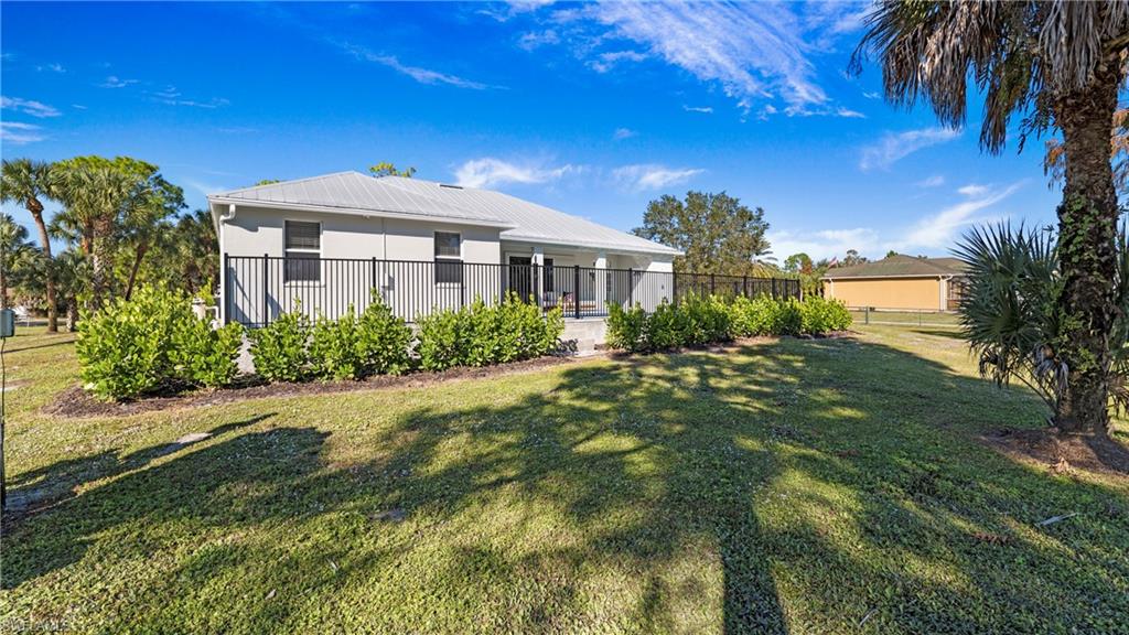770 17th Street Southwest Naples, FL 34117 - Photo 36 of 47 a front view of a house with garden