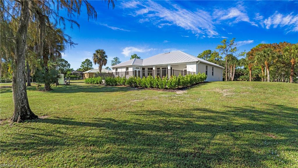 770 17th Street Southwest Naples, FL 34117 - Photo 39 of 47 a front view of a house with a yard