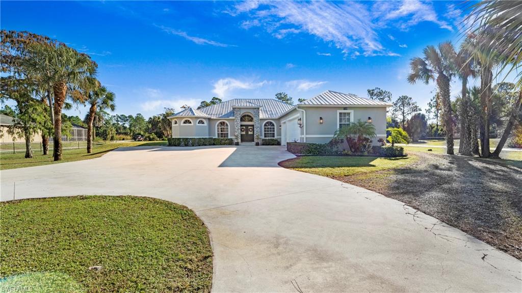 770 17th Street Southwest Naples, FL 34117 - Photo 44 of 47 a view of a big house with a big yard and large tree