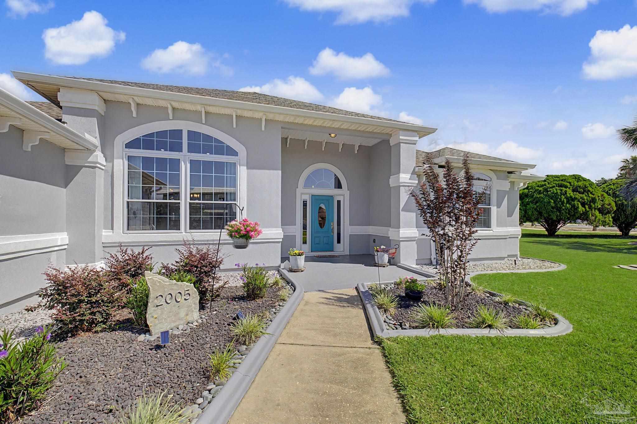 2005 Riviera Lane South Navarre, FL 32566 - Photo 46 of 70 a front view of a house with garden