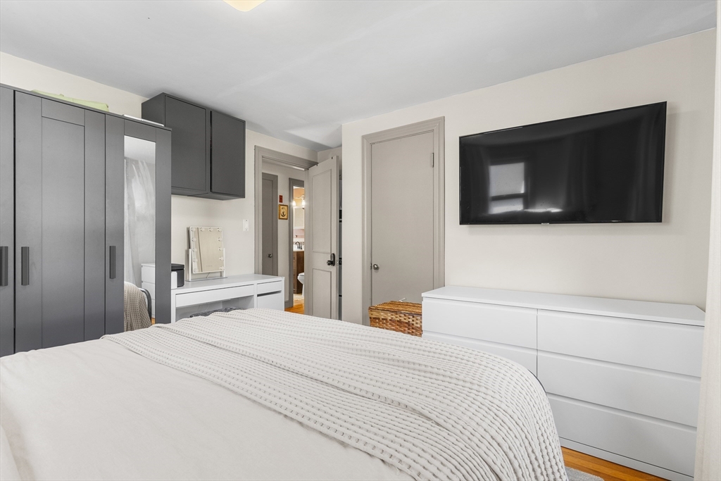 11 Hartlawn Road Boston, MA 02132 - Photo 10 of 34 a bedroom with a bed and a flat screen tv