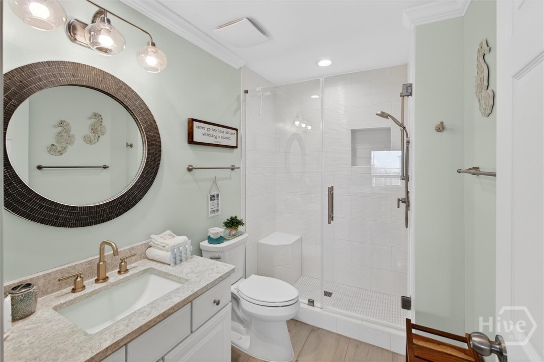101 Butler Avenue, Unit G Tybee Island, GA 31328 - Photo 23 of 40 Primary en-suite with walk-in tile shower