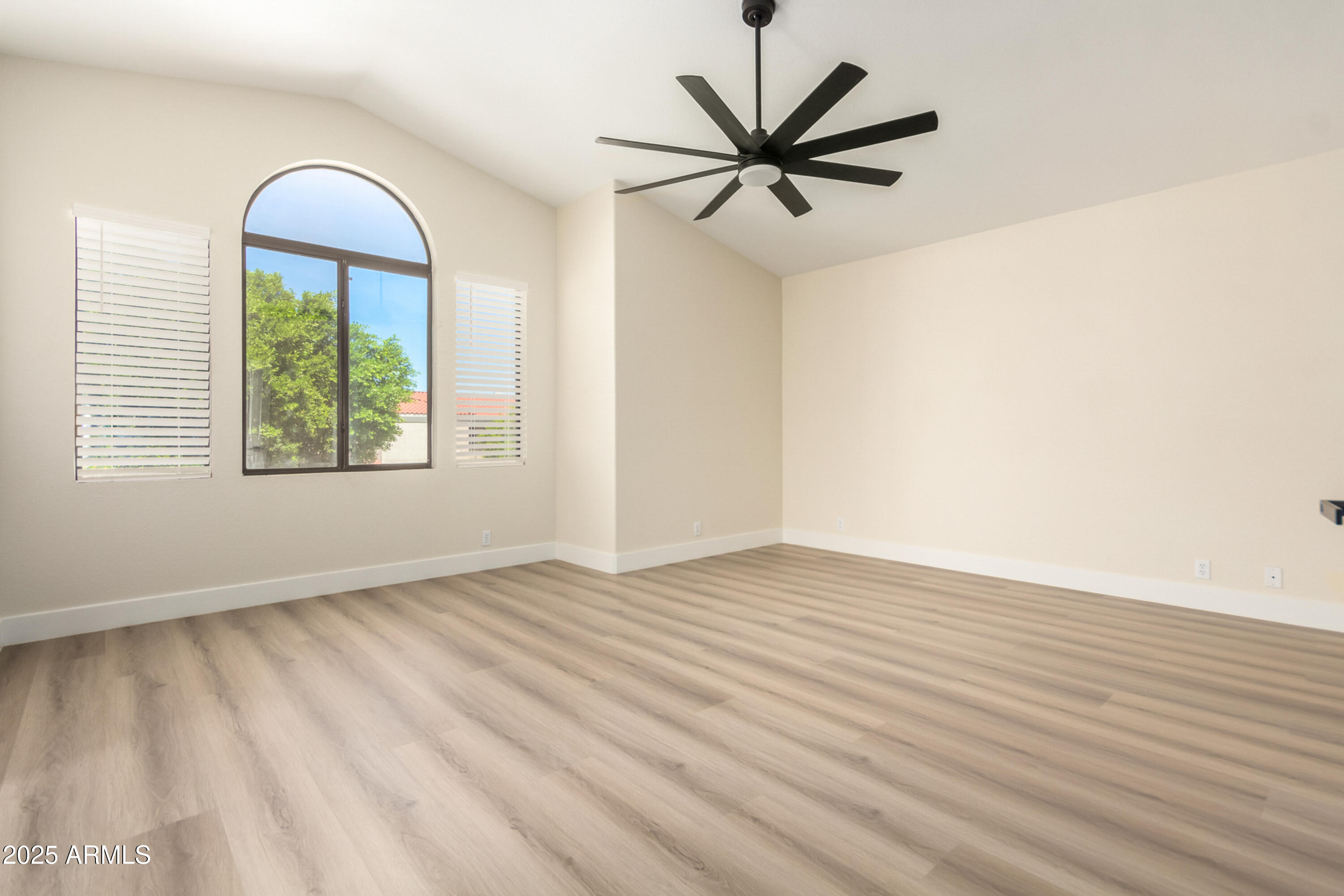 1630 South Lemon Mesa, AZ 85206 - Photo 25 of 55 an empty room with wooden floor chandelier fan and windows