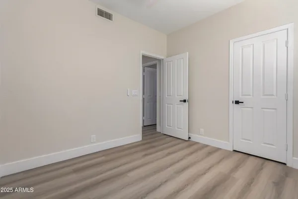 a view of a refrigerator and more cabinets