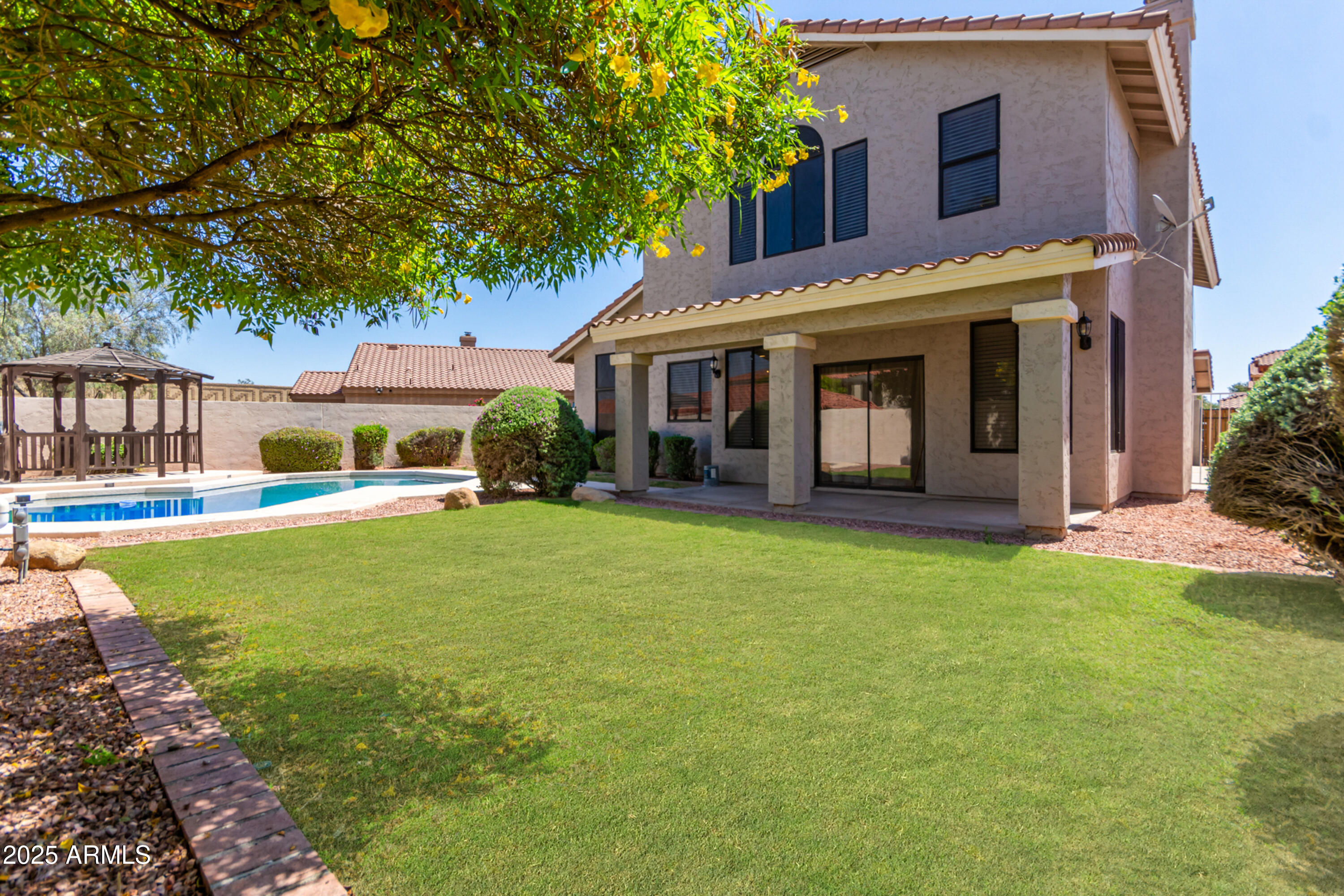1630 South Lemon Mesa, AZ 85206 - Photo 45 of 55 a front view of a house with a garden