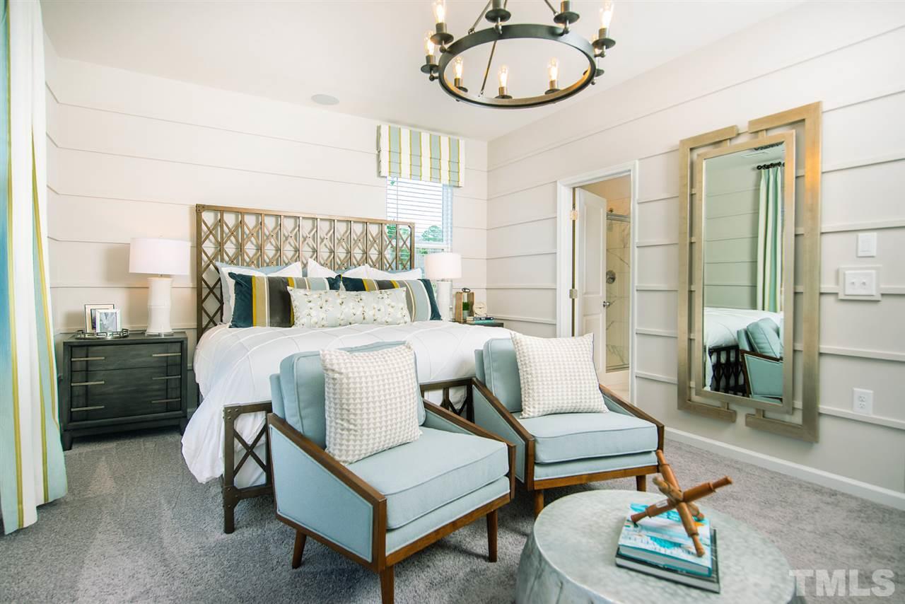 3632 Water Mist Lane, Unit 40 Raleigh, NC 27604 - Photo 11 of 26 a bedroom with a bed a mirror and a rug