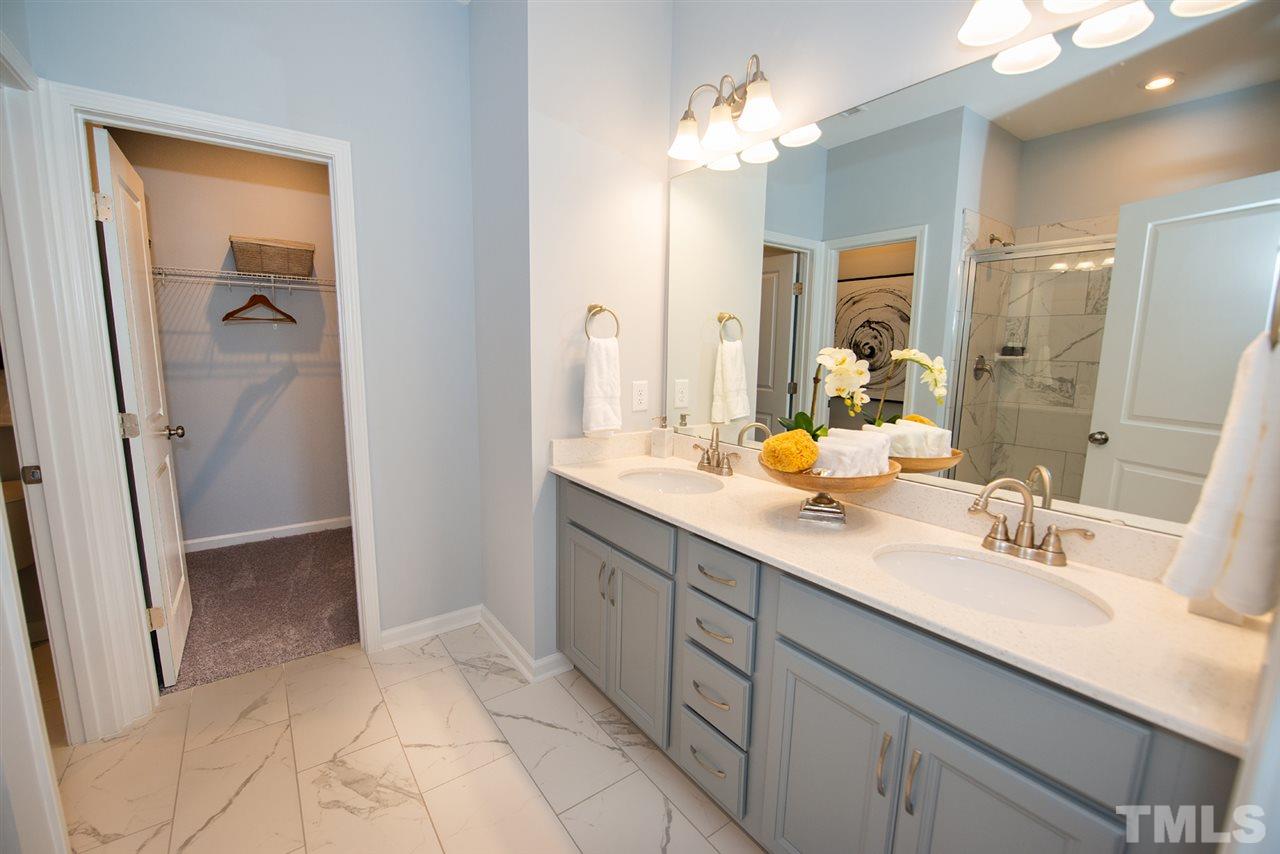 3632 Water Mist Lane, Unit 40 Raleigh, NC 27604 - Photo 12 of 26 a bathroom with a double vanity sink and a mirror