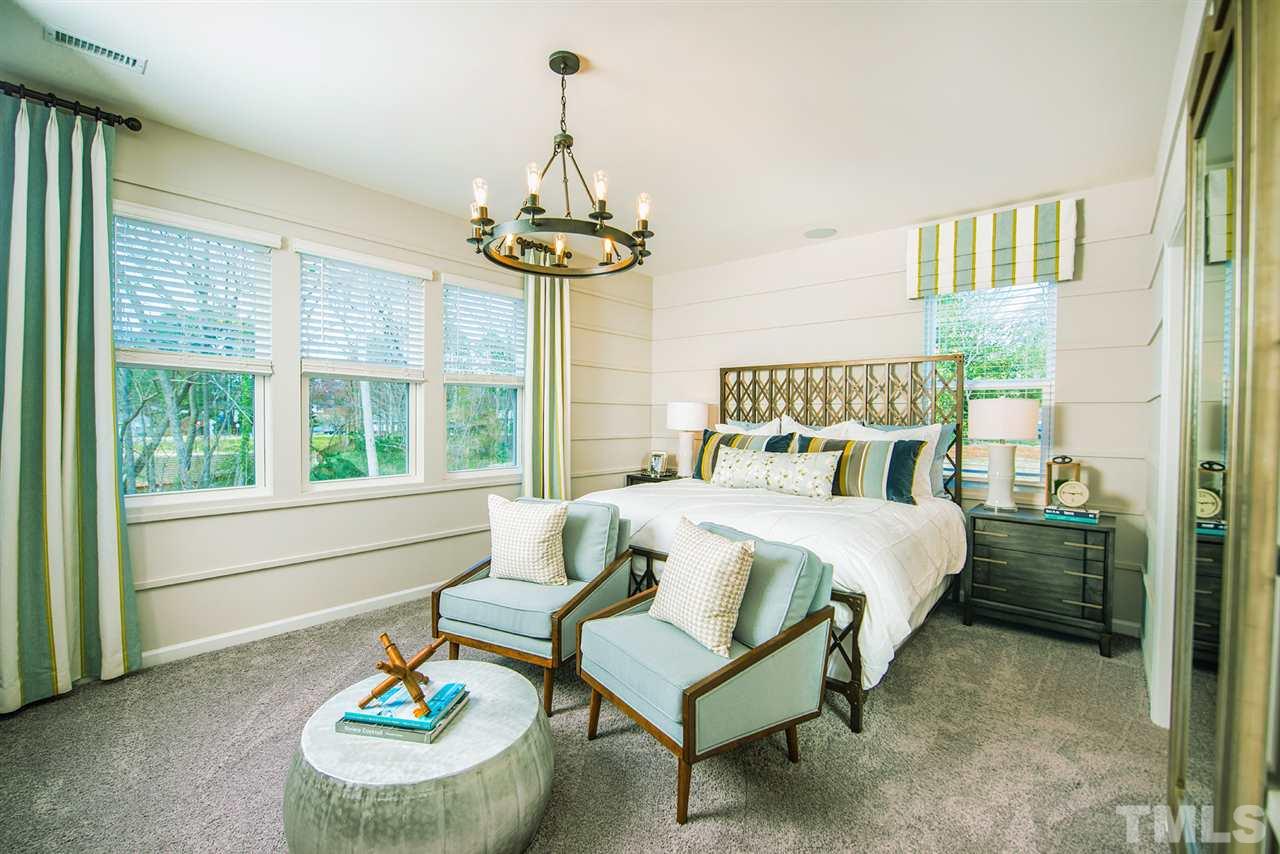 3632 Water Mist Lane, Unit 40 Raleigh, NC 27604 - Photo 10 of 26 a bedroom with a bed and a chandelier