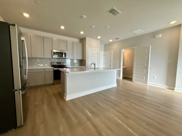 a kitchen with stainless steel appliances a sink and cabinets