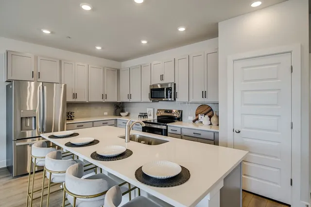 a kitchen with a dining table and chairs
