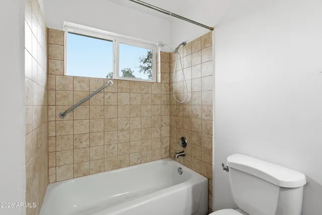 a bathroom with a toilet and bathtub