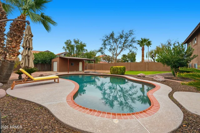 a view of swimming pool with a yard