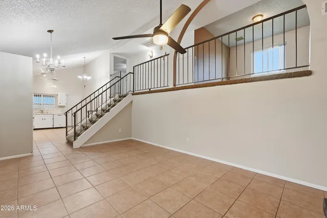 a view of staircase with white walls and a window