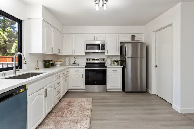 a view of a dining room with furniture large windows and wooden floor
